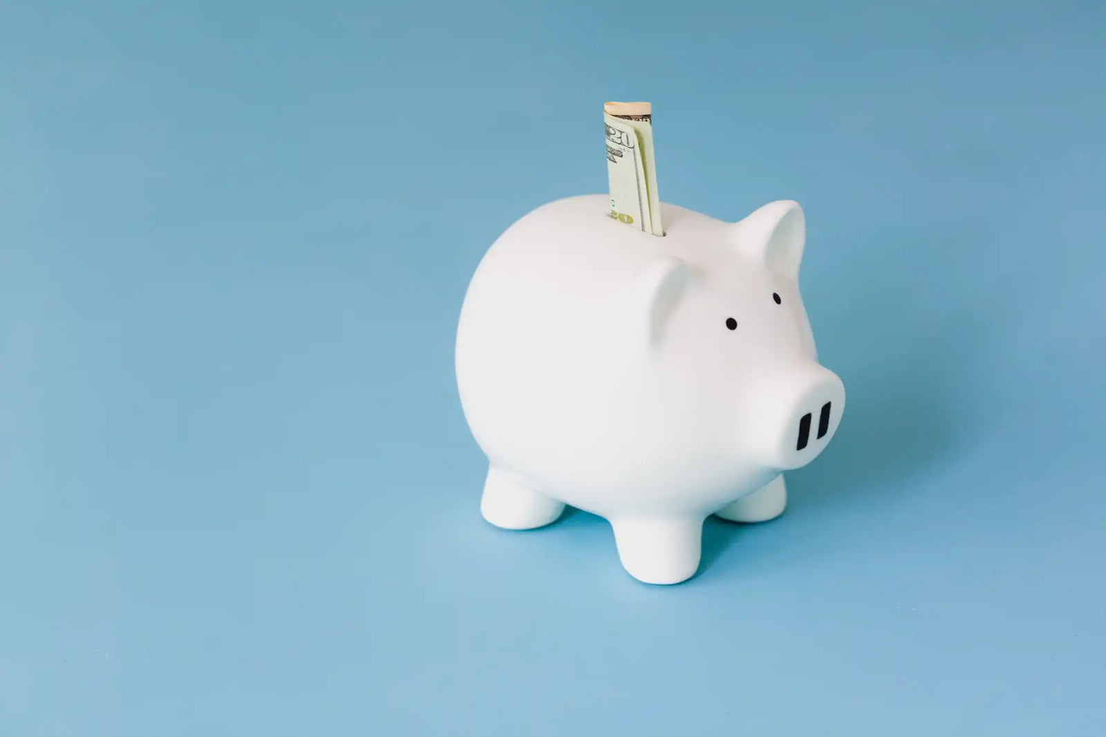 White piggy bank with money.